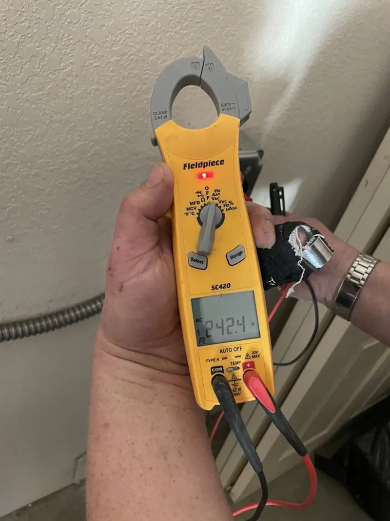 Voltage testing with clamp meter during Whole House Surge Protector in Lake Luzerne